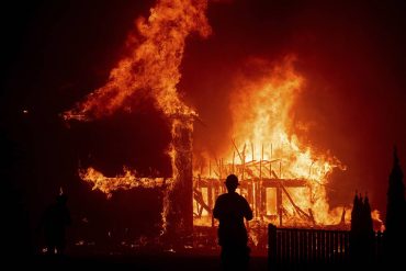 A home burns as the Camp Fire rages through Paradise, Calif., on Thursday, Nov. 8, 2018. Tens of thousands of people fled a fast-moving wildfire Thursday in Northern California, some clutching babies and pets as they abandoned vehicles and struck out on foot ahead of the flames that forced the evacuation of an entire town.(AP Photo/Noah Berger)